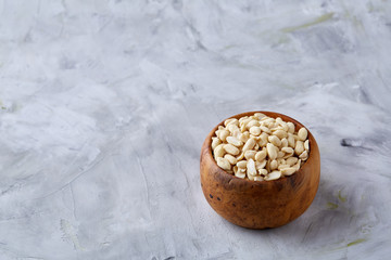 Pile of peelled peanuts isolated on white textured background, background, top view, close-up, selective focus