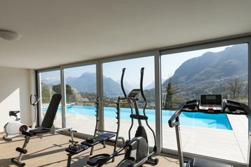 Gym overlooking the pool and hills
