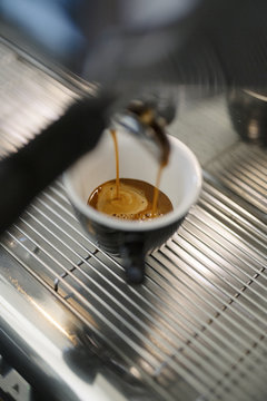 Fresh Espresso Pouring into Ceramic Cup from Professional Coffee Machine