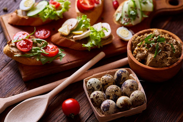 Breakfast still life with sandwiches, quail eggs, spicies and fresh fruits and vegetables, selective focus
