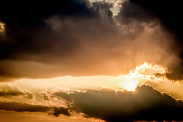 Dramatic evening sunset sky concept with sun rays clouds and empty space for copy or text