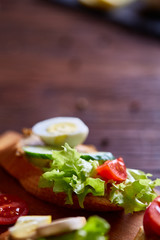 Breakfast still life with sandwiches, quail eggs, spicies and fresh fruits and vegetables, selective focus