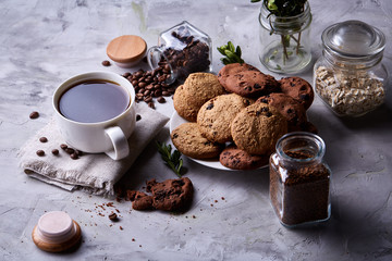 Breakfast background with mug of fresh coffee, homemade oatmeal cookies, grind coffee
