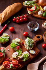 Breakfast still life with sandwiches, quail eggs, spicies and fresh fruits and vegetables, selective focus