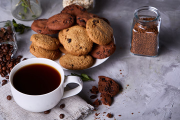 Breakfast background with mug of fresh coffee, homemade oatmeal cookies, grind coffee
