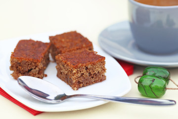 traditional greek coffee with pecan pie dessert and green rosary on the table