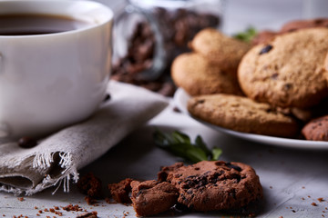 Breakfast background with mug of fresh coffee, homemade oatmeal cookies, grind coffee