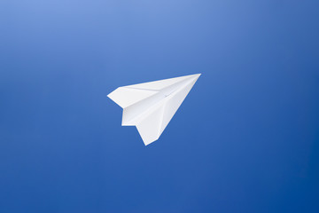 White paper airplane on a blue sky background. The symbol of freedom and privacy on the Internet