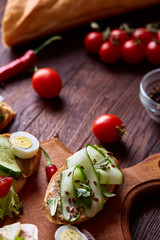 Breakfast sandwich with homemade paste, vegetables and fresh greens, shallow depth of field
