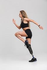 Fototapeta na wymiar Amazing healthy young disabled sportswoman make exercises.