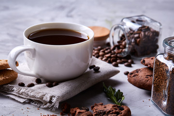 Breakfast background with mug of fresh coffee, homemade oatmeal cookies, grind coffee