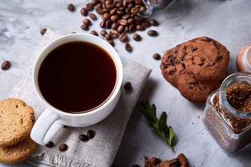 Breakfast background with mug of fresh coffee, homemade oatmeal cookies, grind coffee