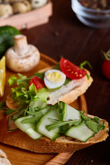 Breakfast sandwich with homemade paste, vegetables and fresh greens, shallow depth of field