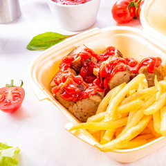 grilled bratwurst with French fries and ketchup
