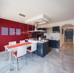 Modern kitchen with island, marble table and leather chairs