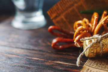 a can of beer with a snack on a wooden dark background . gift bouquet to a man