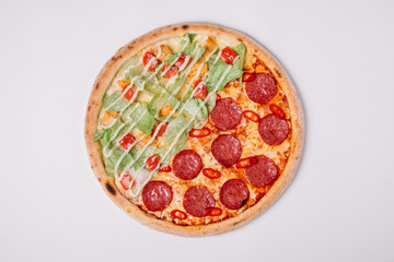 Pizza with salami and chicken isolated on white. 