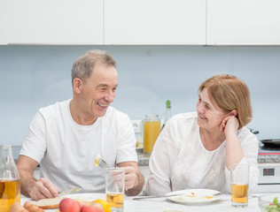 elderly couple have fun in the kitchen