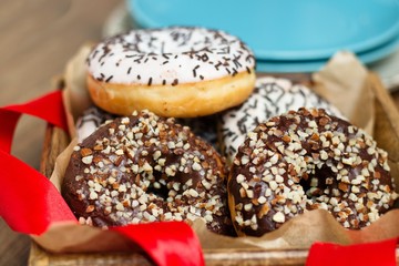 Several donuts in wooden box