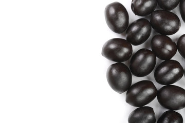 whole black olives isolated on white background with copy space for your text. Top view. Flat lay pattern