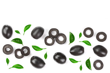 whole and sliced black olives decorated with leaves isolated on white background. Top view. Flat lay pattern