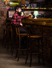Fototapeta na wymiar Guy spend leisure in bar, defocused background.