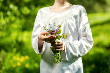 young girl holding a bouquet of wild bright colors