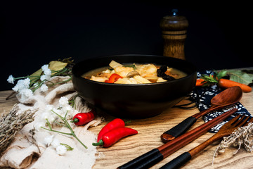 Bowls of Asian soup noodles and vegetables with Chopstick
