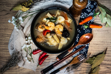 Bowls of Asian soup noodles and vegetables with Chopstick
