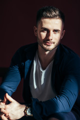 Handsome sexy man portrait on brown background in studio