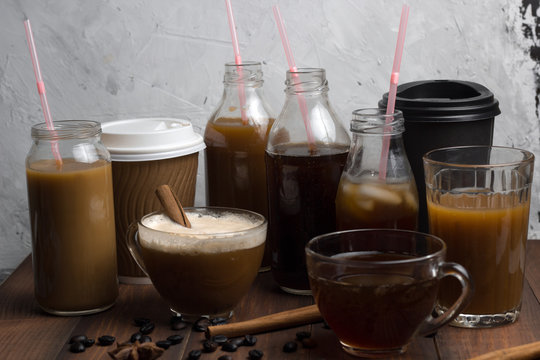 various of  coffee drinks in different cups and bottles concrete background