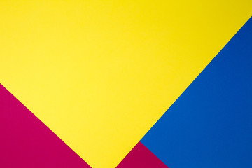 Color papers geometry flat composition background with yellow, red and blue tones