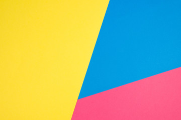 Color papers geometry flat composition background with yellow, pink and blue tones