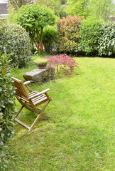 wooden chair in a ornamental countryside garden 