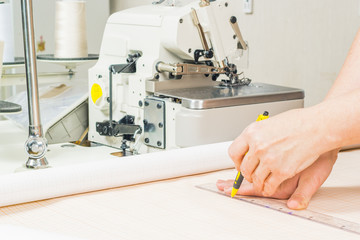 Tailors working with the measuring bar. leucalo