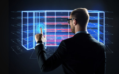 architecture, technology and construction concept - businessman with virtual building blueprint projection on screen
