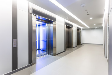 Modern steel elevator door almost open cabins in a business lobby or Hotel, Store, interior,...