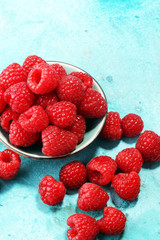 raspberries. Raspberry on blue background. Summer and healthy food concept