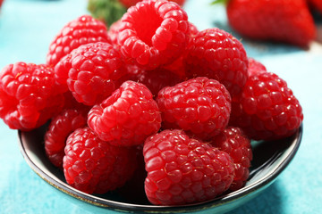 raspberries. Raspberry on blue background. Summer and healthy food concept