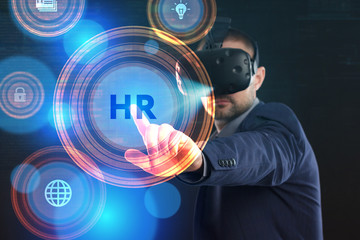 Business, Technology, Internet and network concept. Young businessman working in virtual reality glasses sees the inscription: HR