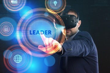 Business, Technology, Internet and network concept. Young businessman working in virtual reality glasses sees the inscription: Leader