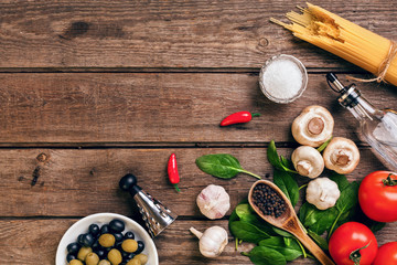 Italian food ingredients for the preparation pasta on wooden background