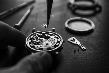 Watchmaker is repairing the mechanical watches in his workshop