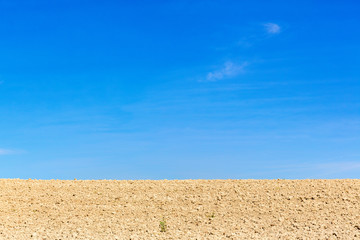 Fototapeta na wymiar Soil field against a blue sky