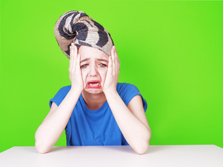 A young teenage actress with smeared mascara and a towel on her head. A crying woman holding her...