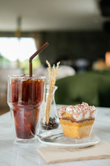 Iced coffee with cake Put on a white table Ready to eat