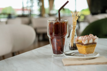 Iced coffee with cake Put on a white table Ready to eat