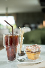 Iced coffee with cake Put on a white table Ready to eat