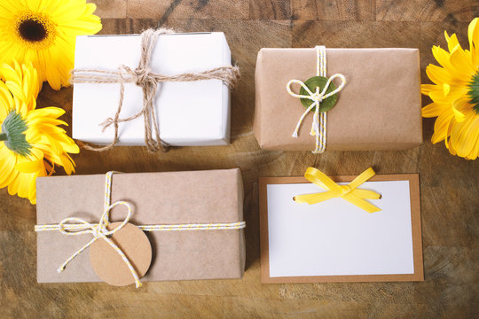 Little gift boxes with with yellow flowers in a rustic style