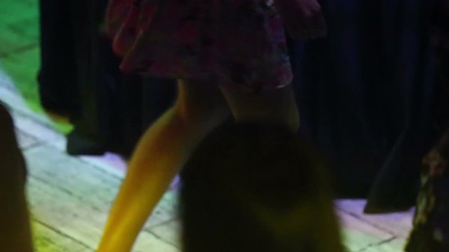 KHANH HOA NHA TRANG/VIETNAM - JUNE 20 2015: Closeup european young slim pretty lbrunette girl dances at discotheque in night club under searchlight on June 20 in Khanh Hoa Nha Trang